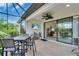 Covered patio with ceiling fan, outdoor TV, and dining table, offering a relaxing outdoor space at 4610 Alexandria Ct, Palmetto, FL 34221