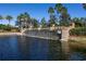 Picturesque community waterfall feature flowing into a serene lake with lush landscaping at 4610 Alexandria Ct, Palmetto, FL 34221