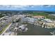 Stunning aerial view of condo building and marina with boat slips surrounded by lush landscaping and waterfront views at 4939 Floramar Ter # 504, New Port Richey, FL 34652