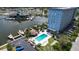Aerial view of the building with community pool, shuffleboard, docks, and marina views at 4939 Floramar Ter # 504, New Port Richey, FL 34652