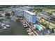 Stunning aerial view of waterfront condo with marina, pool, and meticulous landscaping at 4939 Floramar Ter # 504, New Port Richey, FL 34652