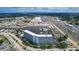 Aerial view of condo building with private marina, boat slips, water access, nearby shopping, and highway access at 4939 Floramar Ter # 504, New Port Richey, FL 34652