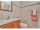 Tiled bathroom featuring a vanity with sink, updated fixtures, and decorative touches at 4939 Floramar Ter # 504, New Port Richey, FL 34652
