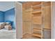 Walk-in closet featuring custom shelving with drawers and a closet rod at 4939 Floramar Ter # 504, New Port Richey, FL 34652