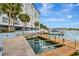 Condo building featuring waterfront access, boat docks, car parking, and tropical landscaping at 4939 Floramar Ter # 504, New Port Richey, FL 34652