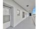 Exterior hallway featuring neutral paint colors, overhead lighting, and access to resident units at 4939 Floramar Ter # 504, New Port Richey, FL 34652