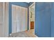 Hallway with closets leading to a bathroom with stylish vanity and mosaic tile at 4939 Floramar Ter # 504, New Port Richey, FL 34652