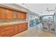 Well-equipped kitchen featuring wood cabinets, and granite countertops at 4939 Floramar Ter # 504, New Port Richey, FL 34652