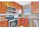 This modern kitchen features stainless steel appliances, granite countertops, and wood cabinets at 4939 Floramar Ter # 504, New Port Richey, FL 34652
