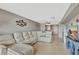 Inviting living room featuring a sectional couch, decorative fish decor, and tile floors at 4939 Floramar Ter # 504, New Port Richey, FL 34652