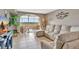 This cozy living room features a large window, tile floors, and comfortable seating for relaxing and entertaining at 4939 Floramar Ter # 504, New Port Richey, FL 34652