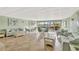 This light and airy lounge area features large windows, tile floors, and comfortable seating for relaxing and entertaining at 4939 Floramar Ter # 504, New Port Richey, FL 34652