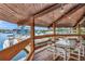 Covered outdoor dining area with marina view, featuring wood flooring and waterfront vistas at 4939 Floramar Ter # 504, New Port Richey, FL 34652