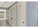 A hallway of white storage lockers for residents with overhead lighting at 4939 Floramar Ter # 504, New Port Richey, FL 34652
