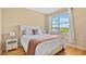 Bright bedroom with hardwood floors, a comfortable bed, and a large window offering natural light and views at 501 Knights Run Ave # 1335, Tampa, FL 33602