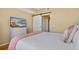 Comfortable bedroom featuring a bed, white dresser with TV, and a barn door to the bathroom and closet at 501 Knights Run Ave # 1335, Tampa, FL 33602