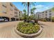 Beautifully landscaped courtyard with a central fountain and colorful flowerbeds within a condo community at 501 Knights Run Ave # 1335, Tampa, FL 33602