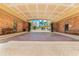 View of the covered driveway entrance into the community, with brick walls and decorative ceiling at 501 Knights Run Ave # 1335, Tampa, FL 33602