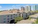 Elegant condo complex with balconies and manicured landscaping against a backdrop of city buildings at 501 Knights Run Ave # 1335, Tampa, FL 33602