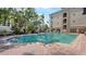 Outdoor swimming pool with stairs and lush vegetation surrounding area at 501 Knights Run Ave # 1335, Tampa, FL 33602