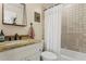 Charming bathroom featuring decorative mirror, stone tile, and shower with curtain at 5017 Muir Way, Lithia, FL 33547