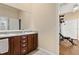 Bathroom with a granite countertop, dual sinks, and wood cabinets at 5017 Muir Way, Lithia, FL 33547