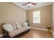 Cozy bedroom featuring hardwood floors, a futon, a ceiling fan, and a window with blinds at 5017 Muir Way, Lithia, FL 33547