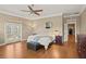 Spacious primary bedroom with hardwood floors and balcony access at 5017 Muir Way, Lithia, FL 33547