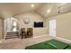 Upstairs bonus room featuring a golf simulator and TV at 5017 Muir Way, Lithia, FL 33547