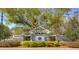 Elegant community entrance with stone pillars, decorative gate, and lush landscaping at 5017 Muir Way, Lithia, FL 33547
