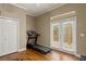 Exercise room featuring a treadmill and balcony access at 5017 Muir Way, Lithia, FL 33547