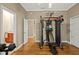 Bright exercise room featuring hardwood floors and modern weight training system at 5017 Muir Way, Lithia, FL 33547
