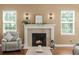 A living room fireplace provides a cozy centerpiece with mantel and natural light at 5017 Muir Way, Lithia, FL 33547
