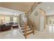 Inviting foyer features curved staircase and flows into the living room at 5017 Muir Way, Lithia, FL 33547