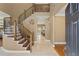 Elegant foyer with a curved staircase, tile floors, and views into adjacent rooms at 5017 Muir Way, Lithia, FL 33547
