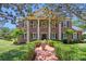 Stunning brick home with stately columns, manicured lawn, and charming front walkway at 5017 Muir Way, Lithia, FL 33547