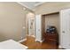Hallway featuring hardwood floors, storage closet, and entry into an on-suite bathroom at 5017 Muir Way, Lithia, FL 33547