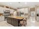 Spacious kitchen featuring a center island with seating, stainless steel appliances, and white cabinetry at 5017 Muir Way, Lithia, FL 33547