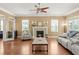 Cozy living room with fireplace, mantle and hardwood floors with backyard views at 5017 Muir Way, Lithia, FL 33547