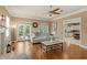 Comfortable living room featuring hardwood floors, natural light, and backyard access at 5017 Muir Way, Lithia, FL 33547