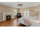 Comfortable bedroom featuring a fireplace, balcony access, and hardwood floors at 5017 Muir Way, Lithia, FL 33547