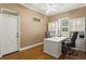 Bright office space featuring hardwood floors, a large white desk, and custom built-in cabinets for ample storage at 5017 Muir Way, Lithia, FL 33547