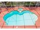 Aerial view of a screened in private pool surrounded by a brick pool deck at 5017 Muir Way, Lithia, FL 33547