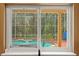 View of pool area and covered patio through a window at 5017 Muir Way, Lithia, FL 33547