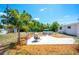 Inviting backyard features a patio with seating, a manicured lawn, mature landscaping and an above ground pool at 5365 Flamingo Dr, St Petersburg, FL 33714