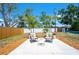 Inviting backyard features a patio with seating, a manicured lawn, and mature landscaping at 5365 Flamingo Dr, St Petersburg, FL 33714
