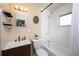 This bathroom boasts a sleek vanity, modern fixtures, and bright, fresh tile for a clean aesthetic at 5365 Flamingo Dr, St Petersburg, FL 33714