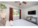 Comfortable bedroom featuring a large window, ceiling fan, and modern decor at 5365 Flamingo Dr, St Petersburg, FL 33714