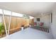 Inviting covered carport with outdoor seating area, a decorative rug, string lights and views of the fenced backyard at 5365 Flamingo Dr, St Petersburg, FL 33714