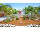 Charming home featuring a landscaped front yard, stone pathway, and a welcoming coral-colored front door with wreath at 5365 Flamingo Dr, St Petersburg, FL 33714